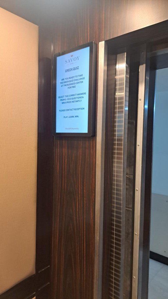 15.6-inch portrait screen beside the lift doors at Savoy Hotel, Bur Dubai
