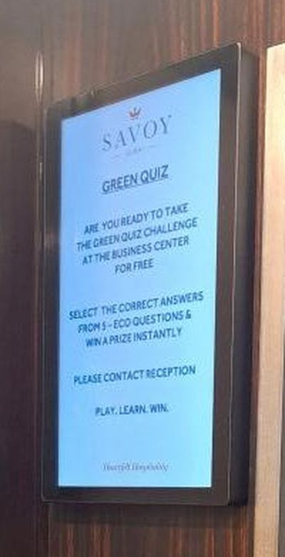 Close-up of the Savoy Green Quiz promotion on the lift screen